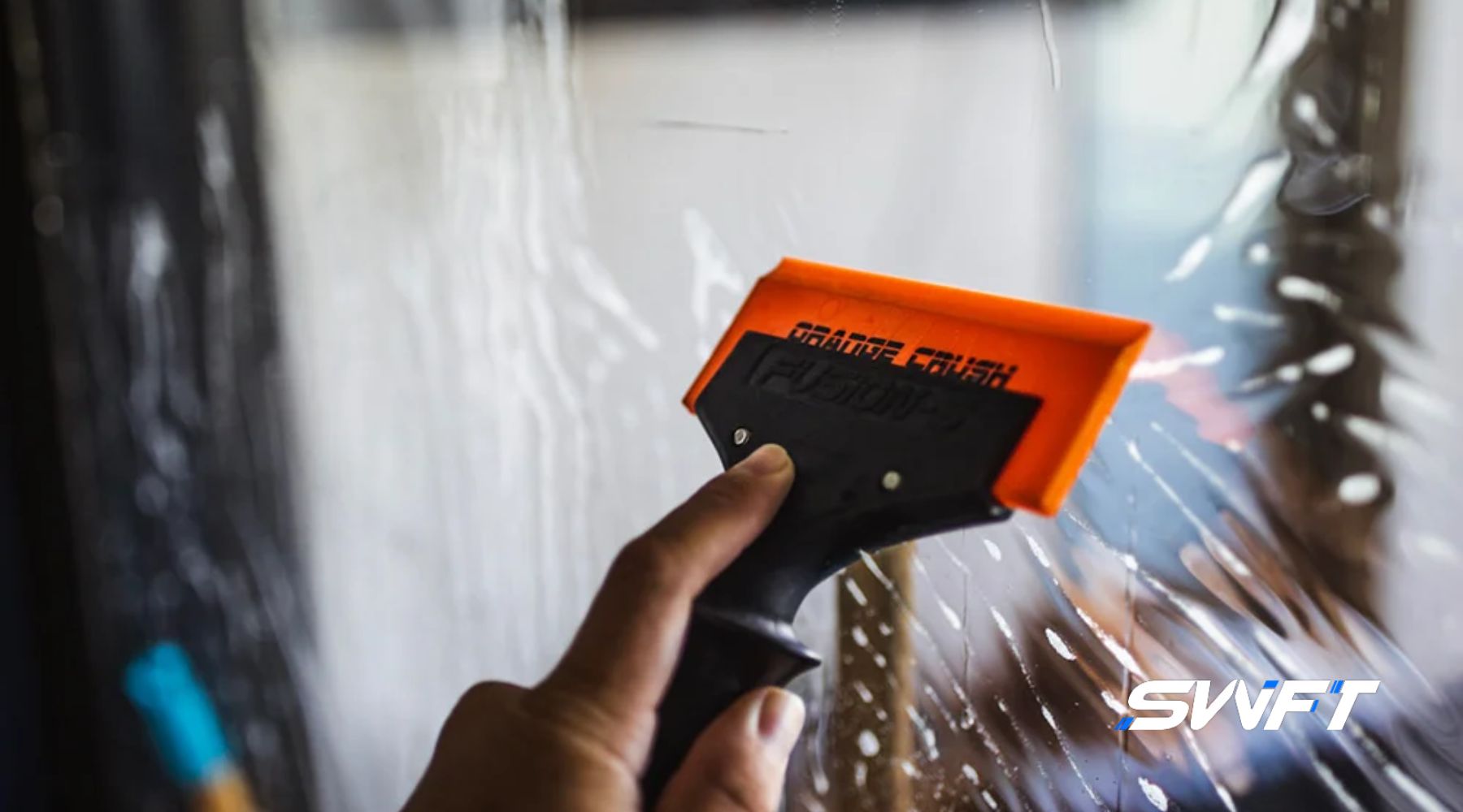 Close-up of a person applying window film with an orange squeegee tool, next to bold text reading "What Is Residential Window Tinting? A Fort Myers, FL Homeowners Guide," introducing the concept of residential tinting for sunlight control and privacy.